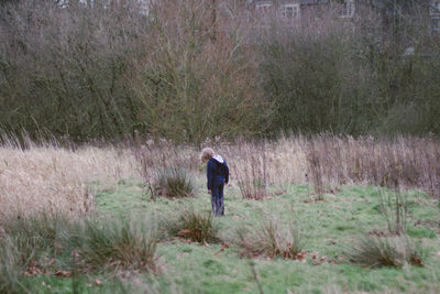 People walking on field in forest