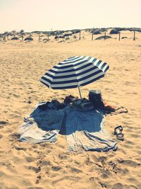 High angle view of fabric and beach umbrella at sandy beach