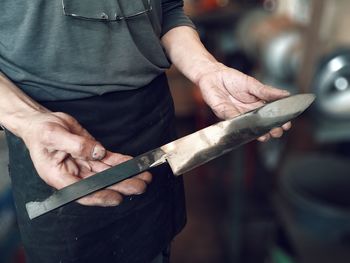 Close-up of cropped hand holding machine