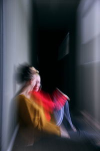 Blurred motion of woman at home