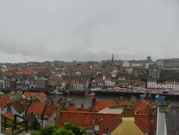 Houses in city against sky