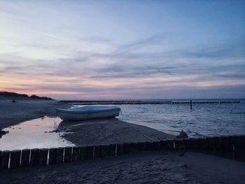 Scenic view of beach against sky during sunset