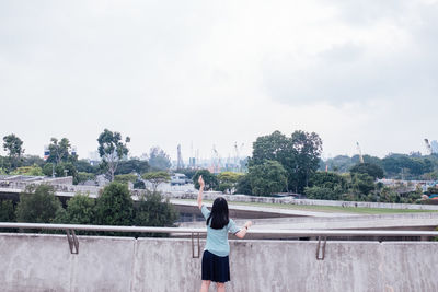 Woman standing on tree trunk
