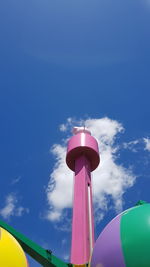 Low angle view of red tower against blue sky
