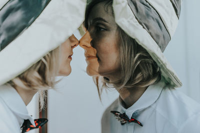 Close-up of woman looking at mirror reflection