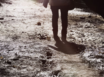 Low section of man standing on field