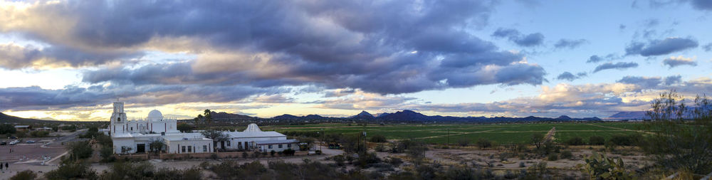 Panoramic view of village against cloudy sky