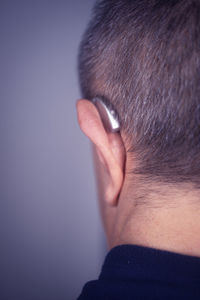 Rear view of a man against blue background