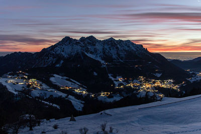 Scenic view of snowcapped mountains against sky during sunset