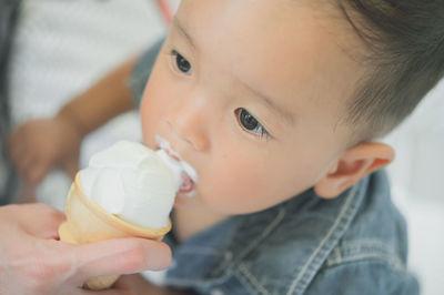 Close-up portrait of cute baby eating food