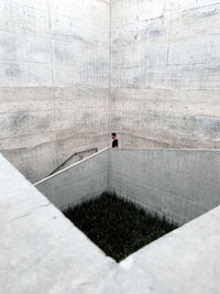 High angle view of people walking on concrete wall