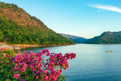 Scenic view of lake and mountains against sky