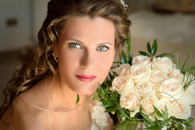 High angle portrait of beautiful bride with roses at home