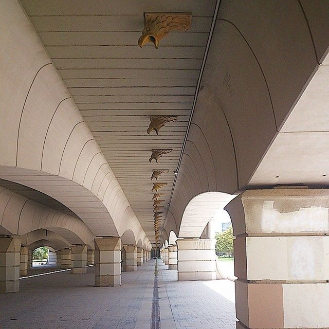 architecture, built structure, indoors, the way forward, ceiling, arch, diminishing perspective, transportation, vanishing point, connection, lighting equipment, incidental people, empty, corridor, bridge - man made structure, building, tunnel, walkway, in a row, day