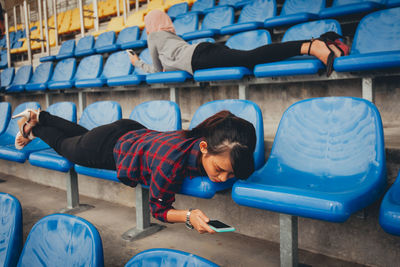 Full length of a boy sitting on seat