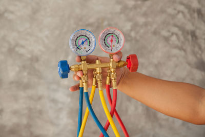 Close-up of hand holding multi colored equipment
