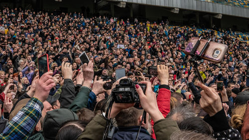 Group of people photographing at music concert