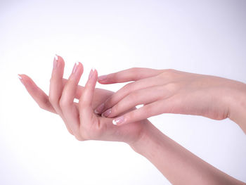 Close-up of hands over white background