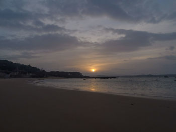 Scenic view of beach against sky during sunset