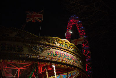 Low angle view of illuminated ferris wheel