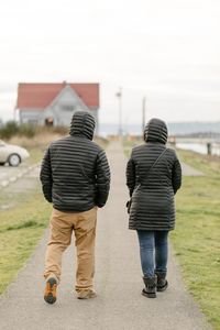 Rear view of people walking outdoors