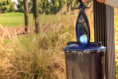 Black golf ball cleaner station on a golf course.