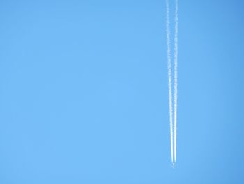 Airplane flying against clear blue sky