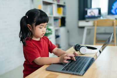 Young woman using laptop at home