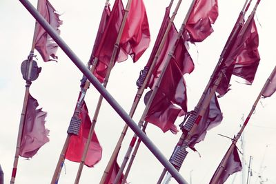 Low angle view of flags hanging against sky