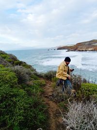 Full length of man on beach against sky