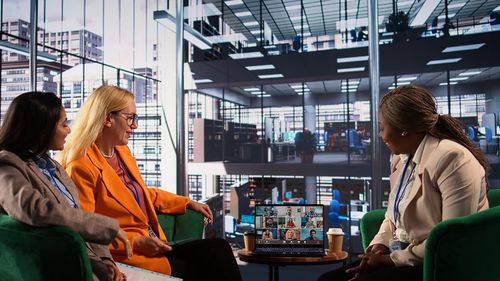 Rear view of woman using mobile phone while standing in city