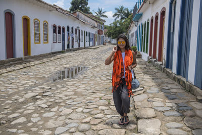 Woman walking through the streets of paraty in brazil