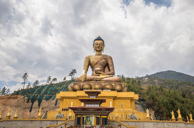 Low angle view of statue against sky