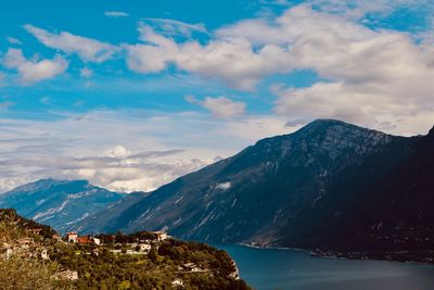 Scenic view of sea and mountains against sky