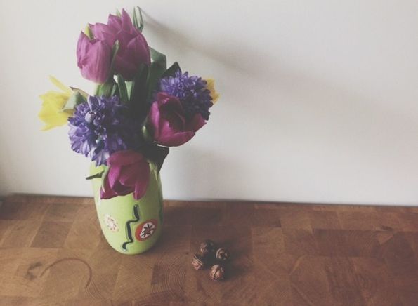 flower, indoors, vase, table, freshness, fragility, petal, wall - building feature, home interior, still life, decoration, pink color, flower head, flower arrangement, close-up, no people, wall, animal representation, potted plant, glass - material