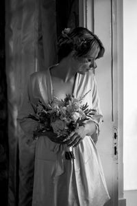 Rear view of woman holding bouquet