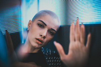 Portrait of young woman holding camera