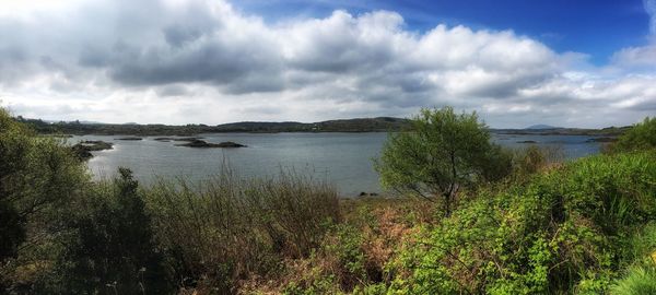 Scenic view of lake against cloudy sky