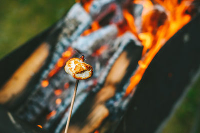 Close-up of marshmallow against fire outdoors