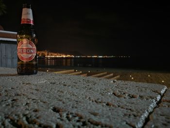 Beach by sea against sky at night