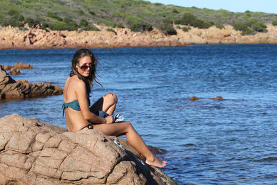 Portrait of young woman sitting on beach