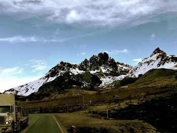 Road amidst mountains against sky