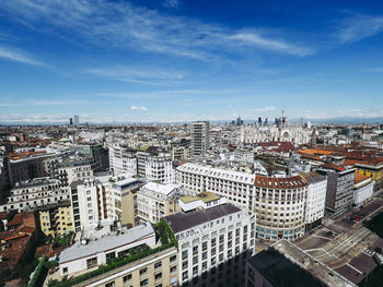Aerial view of cityscape against sky during sunny day