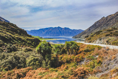 Scenic view of lake and mountains against sky