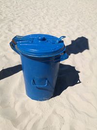 High angle view of blue plastic on sand at beach