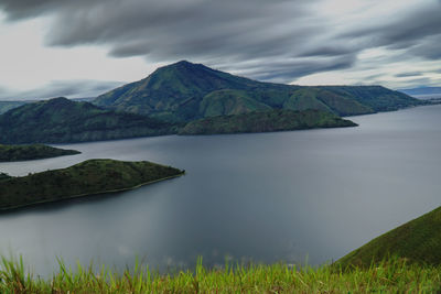 Scenic view of lake and mountains against sky