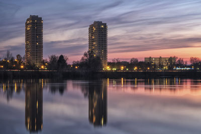 Reflection of city in water at sunset