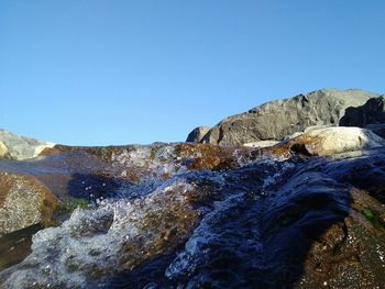 Scenic view of rock formation against clear blue sky