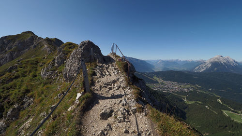 Scenic view of mountains against clear blue sky