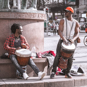 Men sitting in city